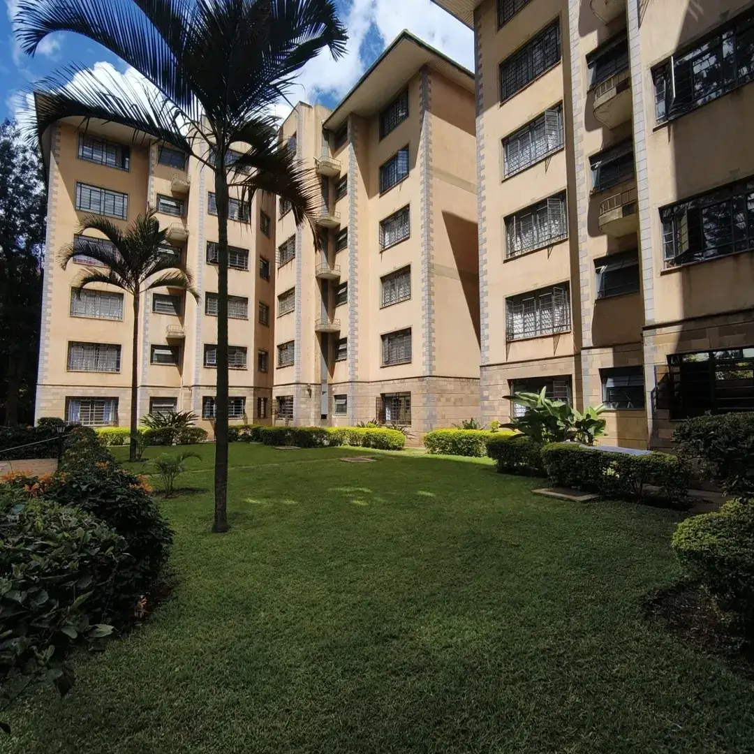 Landscaped compound grounds with manicured lawn and palms