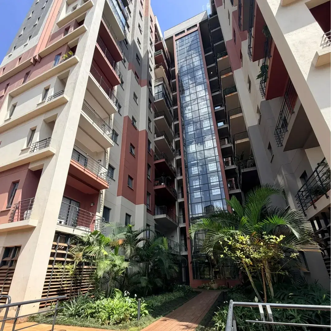 Modern multi-story residential building with landscaped courtyard