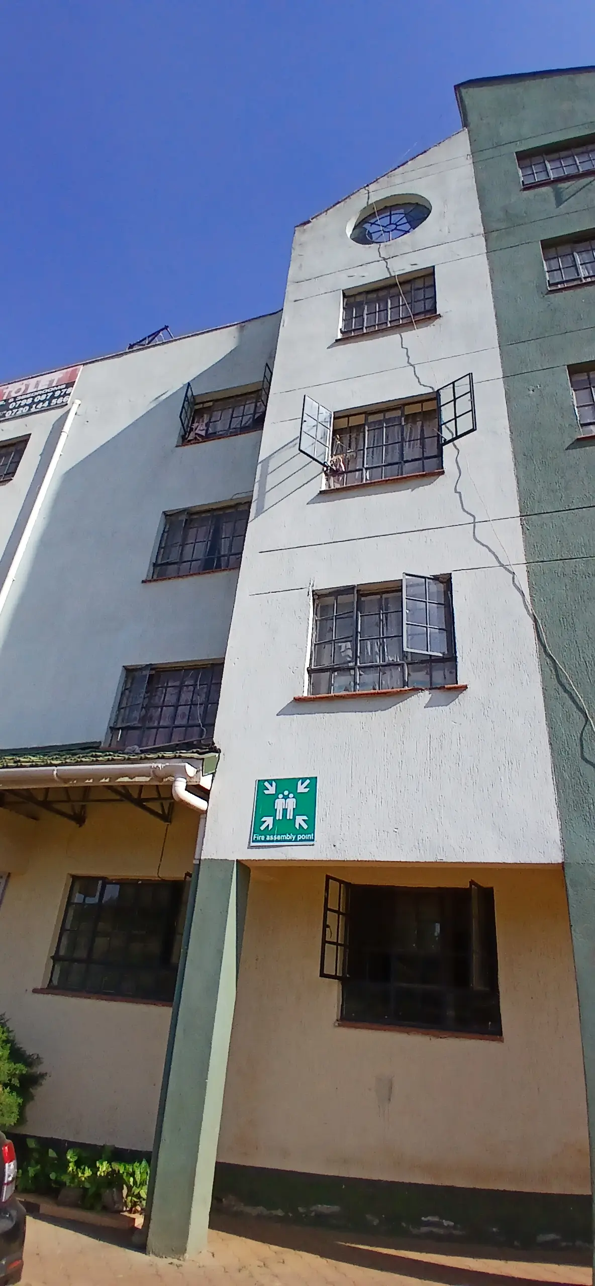 Multi-story residential building facade with symmetrical windows