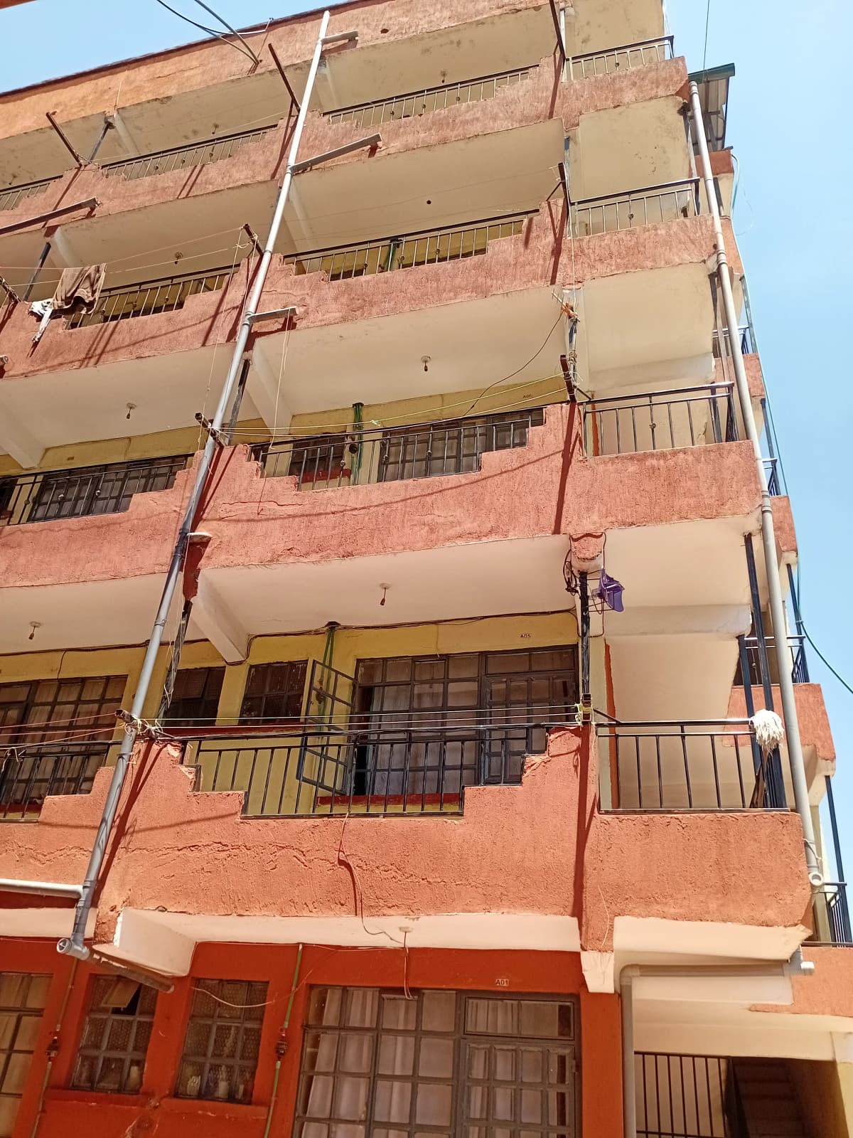 Multi-story residential building facade with balconies and metal railings