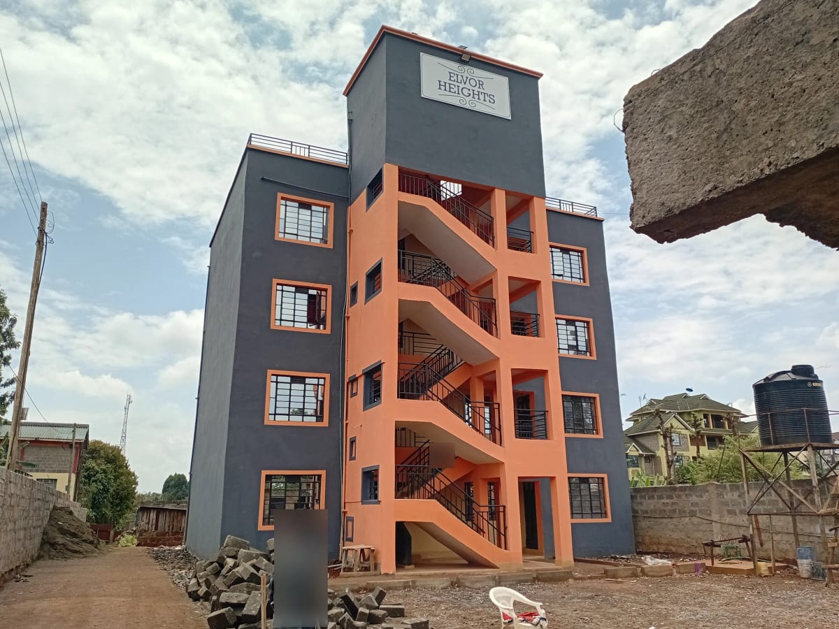 Modern multi-story residential building with orange and gray facade