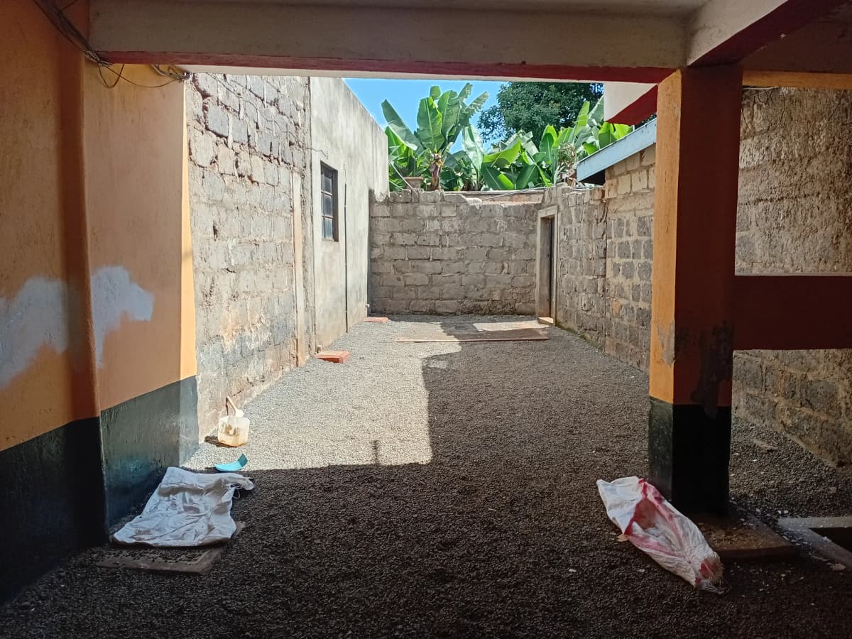 Covered carport with concrete floor and block walls