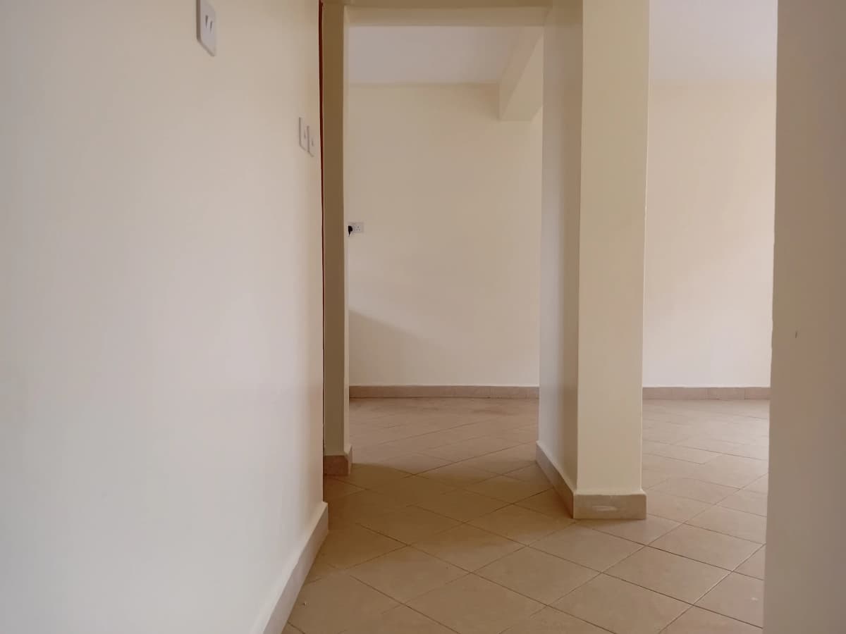 Empty corridor with tile flooring and support columns