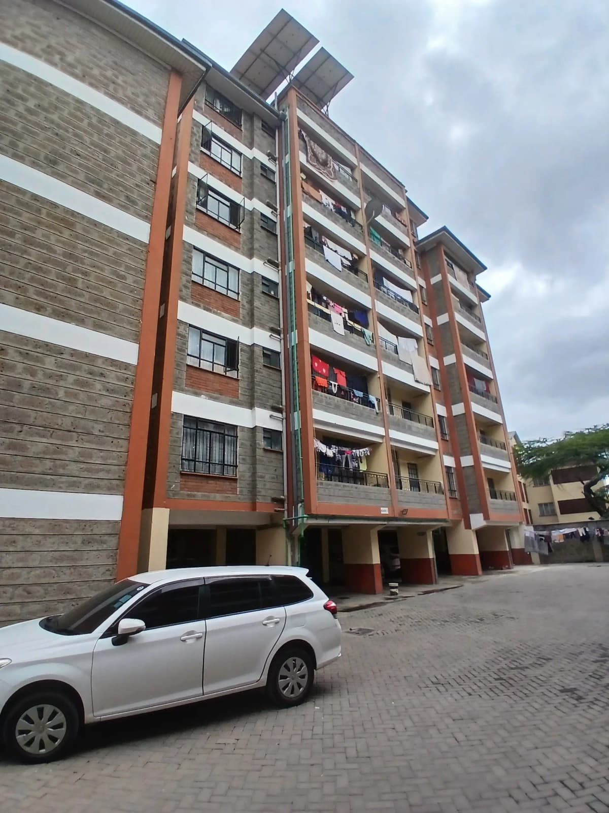 Multi-story residential building facade with ground-level parking