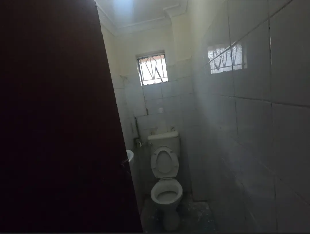 Compact bathroom with toilet and small window openings