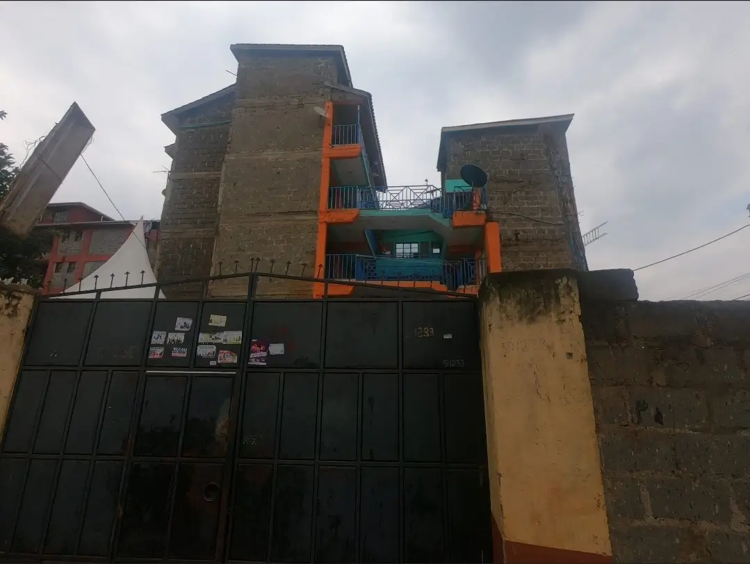 Modern residential building facade with orange and teal accents