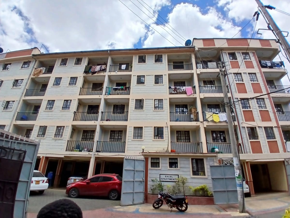 Multi-story residential building facade with ground-level parking