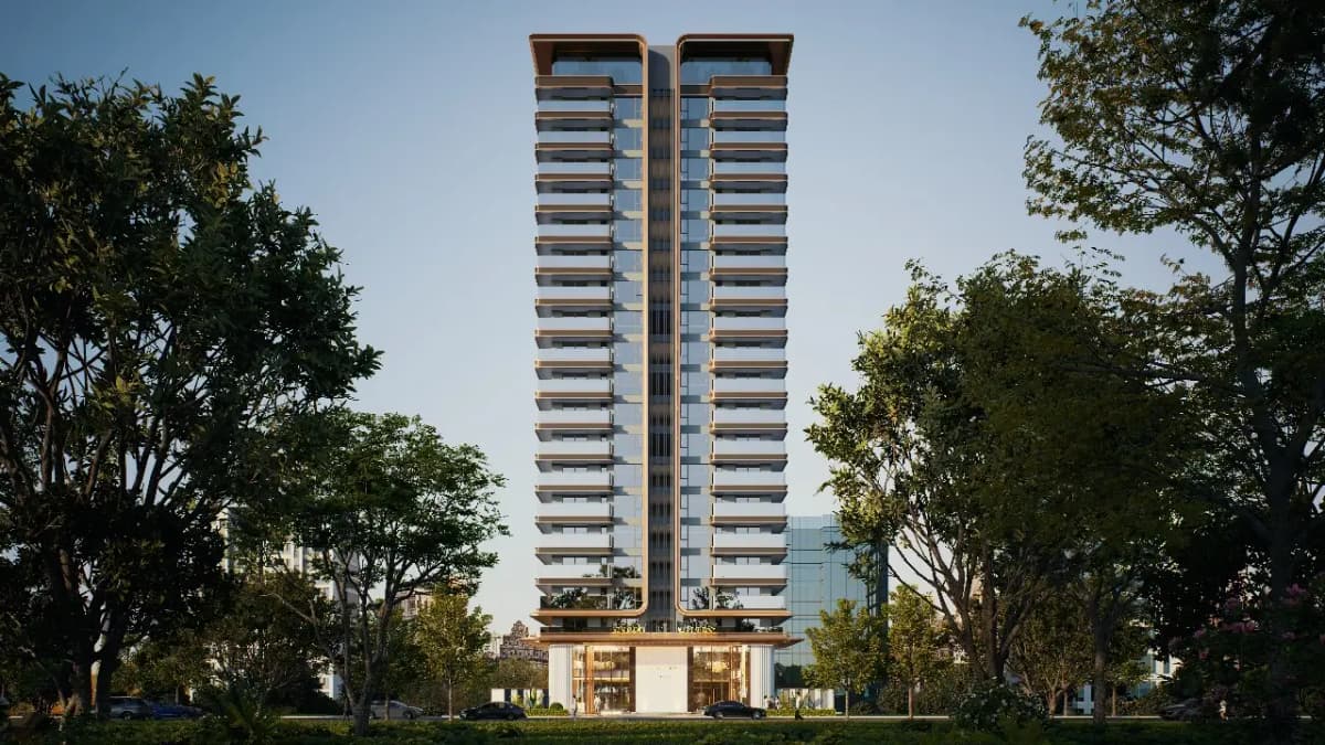 Tall modern high-rise tower surrounded by lush trees