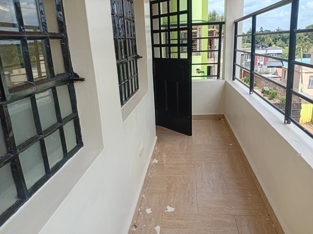 Spacious balcony with city views and black-framed windows