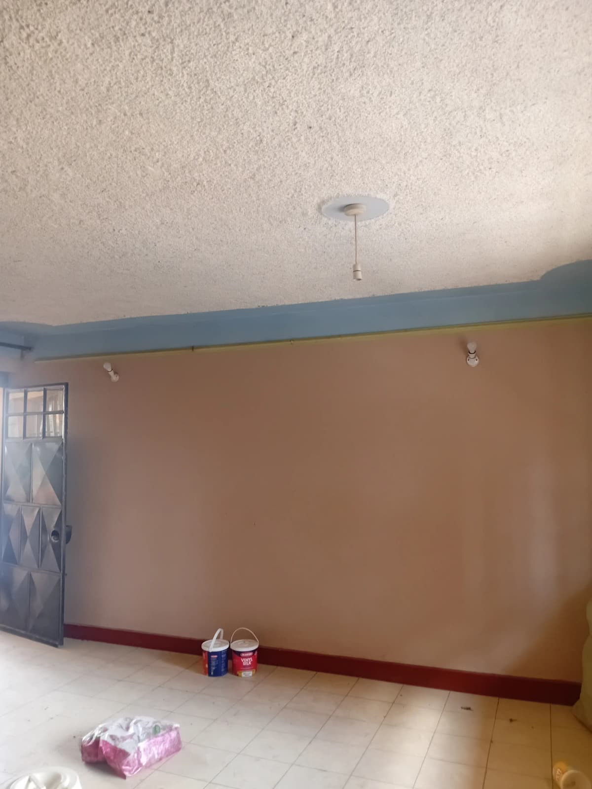 Empty living room with textured ceiling and two-tone painted walls