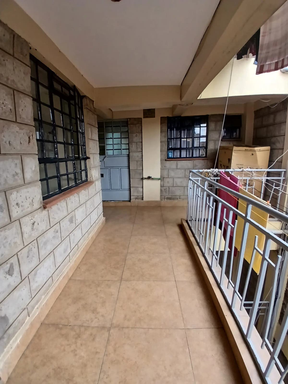 Building corridor with tiled floors and secure metal gates