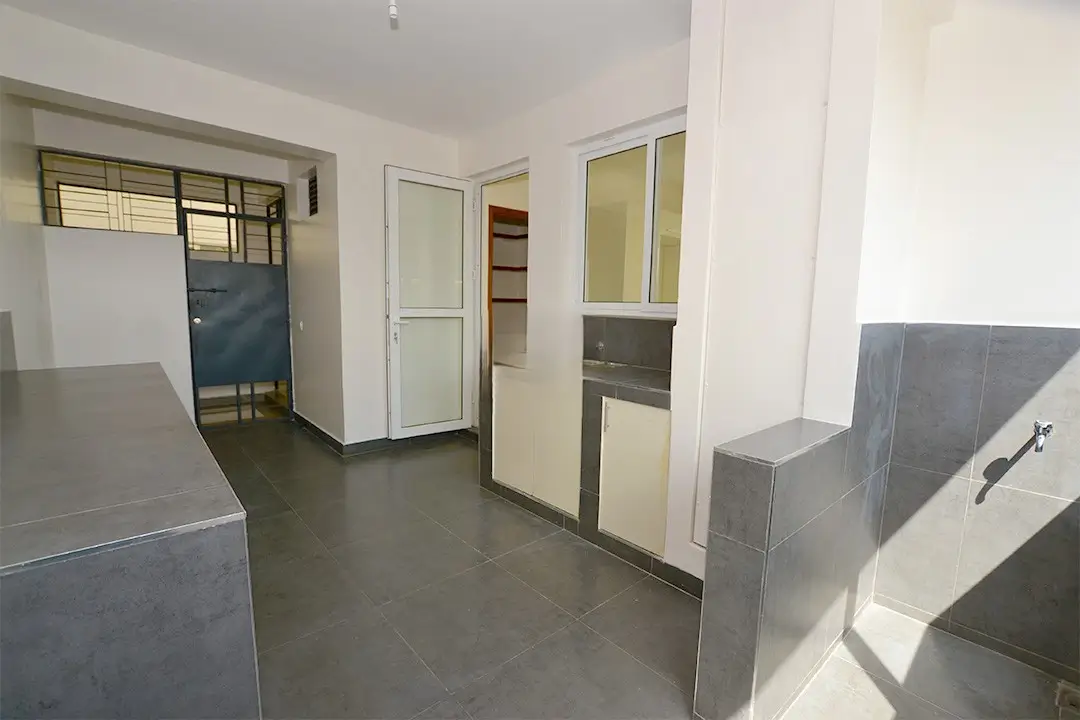 Open-plan kitchen with built-in storage and pantry area