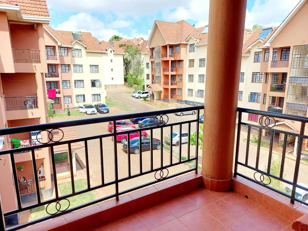 Balcony overlooking residential compound with red rail