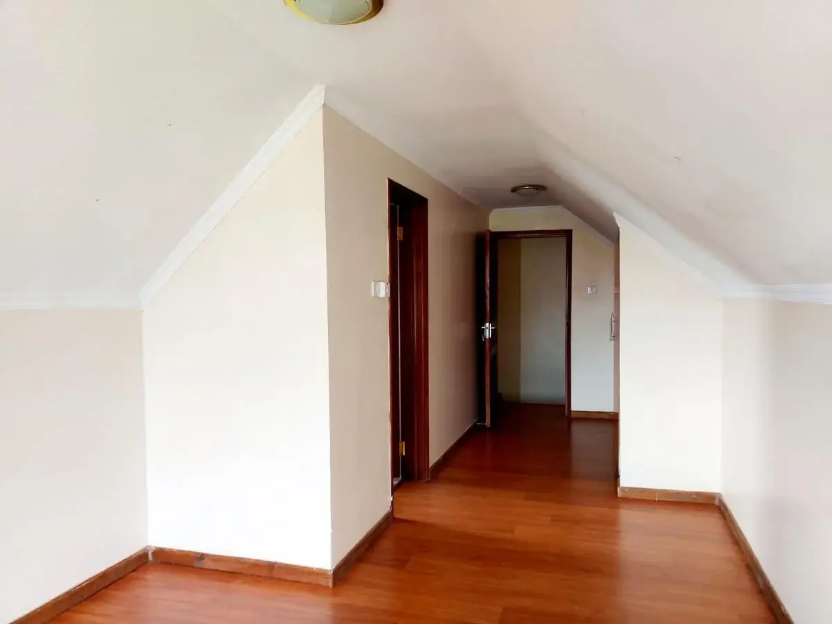 Bright hallway with wooden flooring and multiple doors