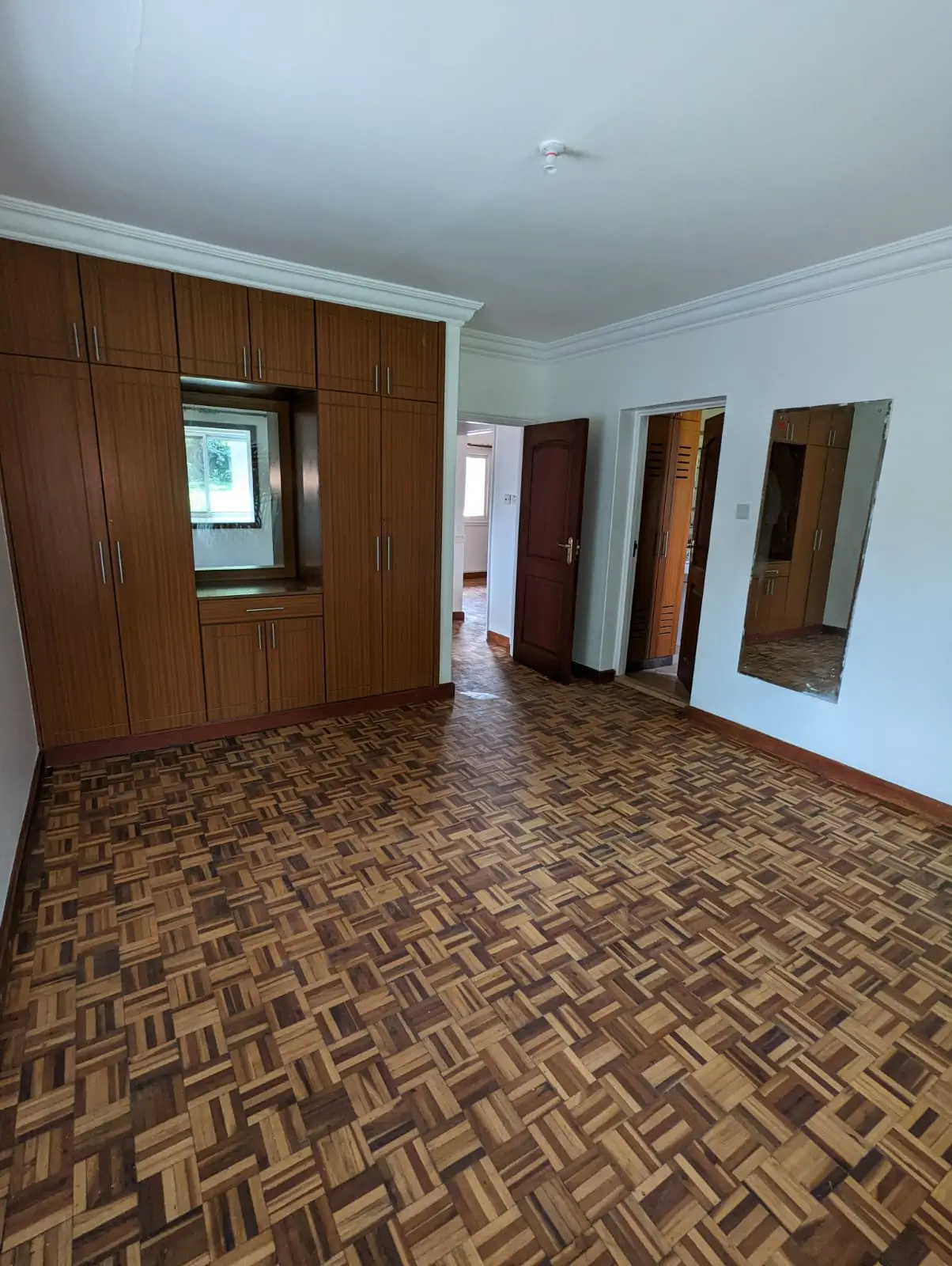 Building corridor with wooden doors and herringbone flooring