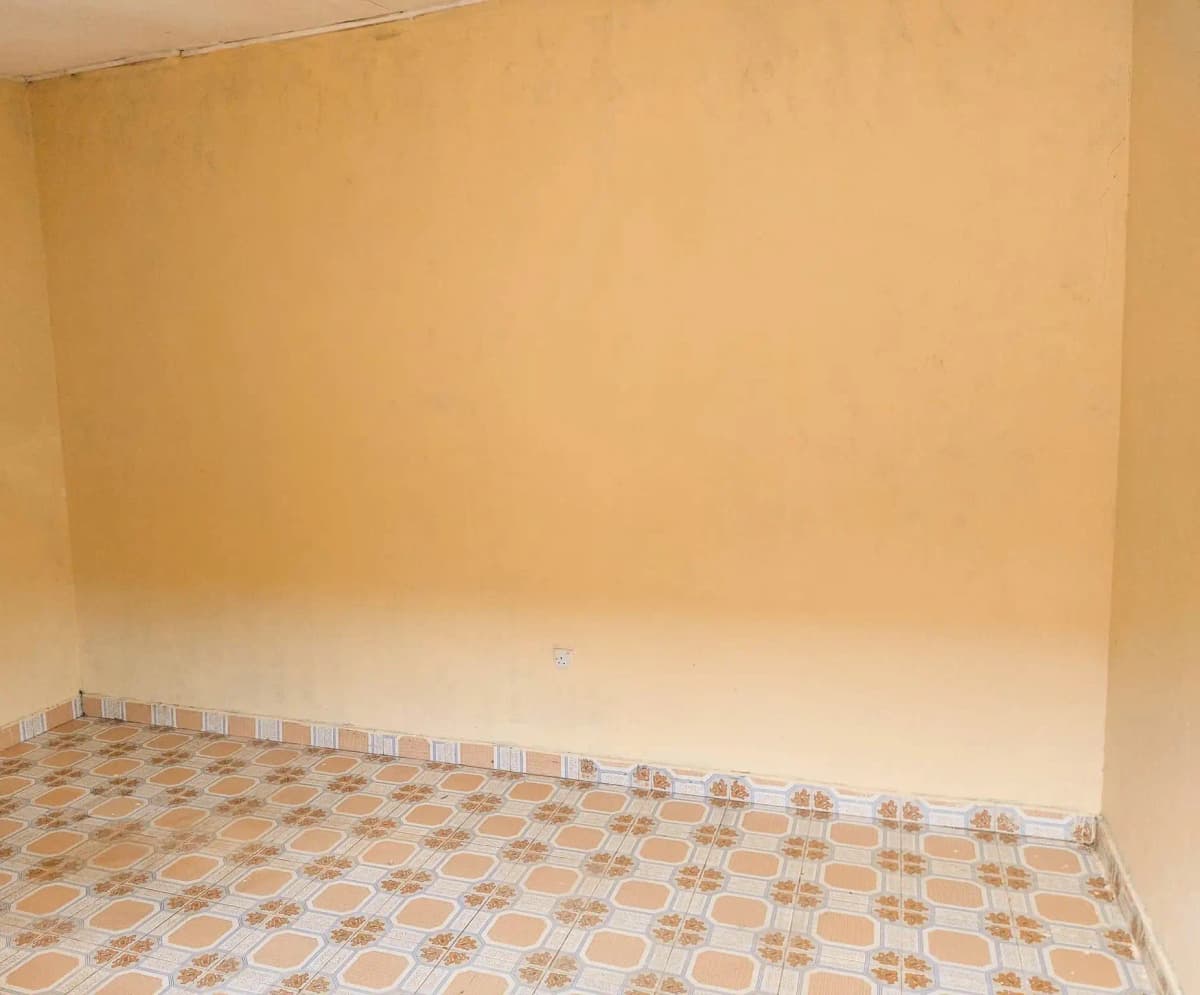 Empty bedroom with geometric tile flooring and bare walls