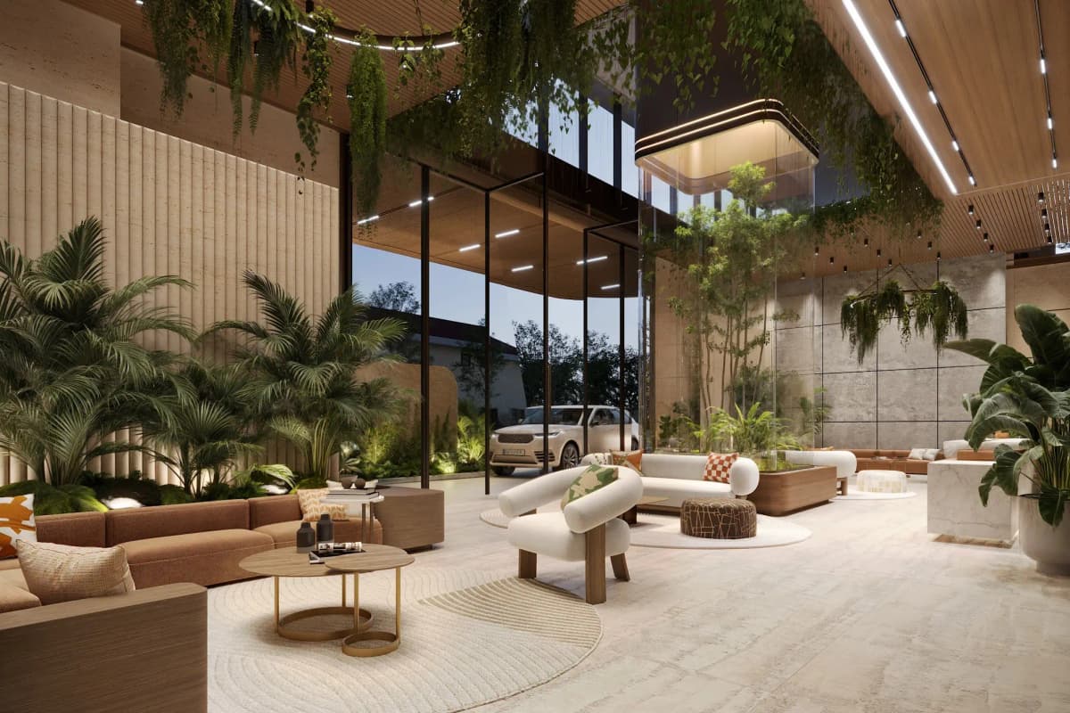 Luxury double-height lobby with lush tropical plants and seating