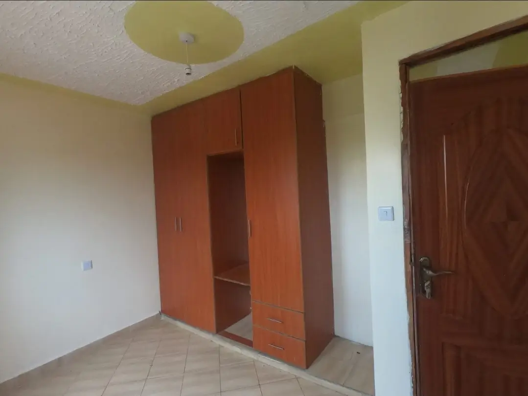 Unfurnished bedroom with orange built-in wardrobe