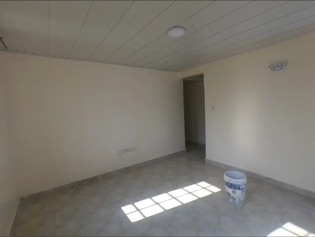 Empty living room with concrete floor and natural light