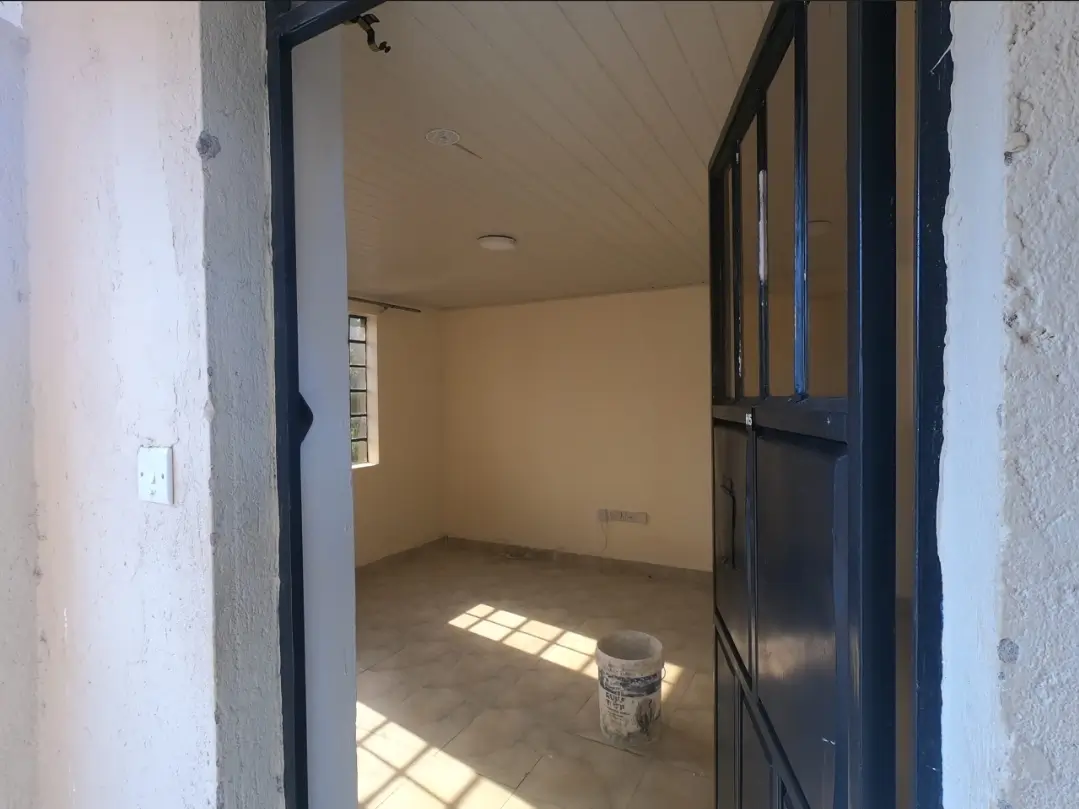 Unfurnished bedroom with natural light and black door frame