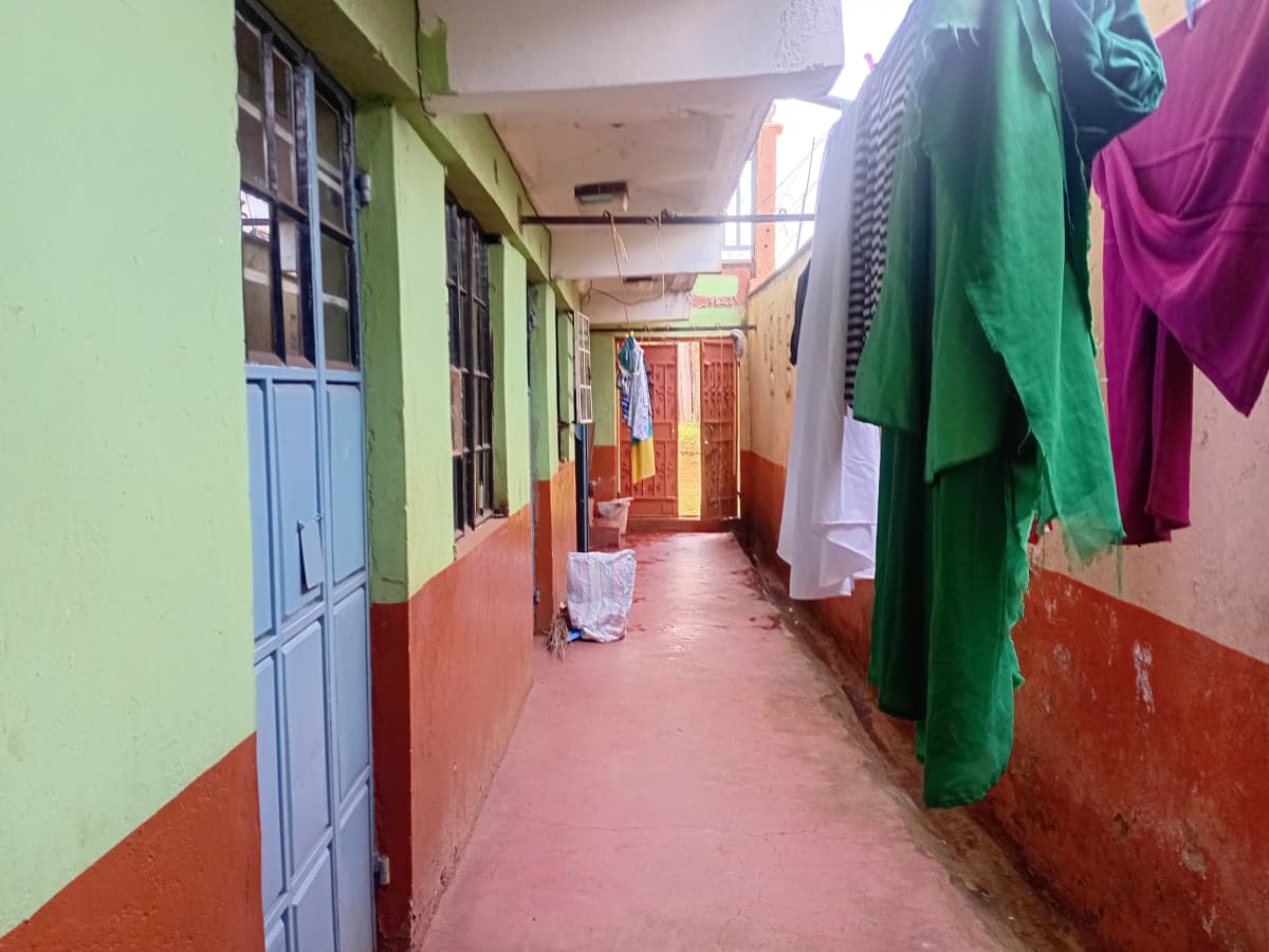 Corridor with clothes hanging to dry on lines