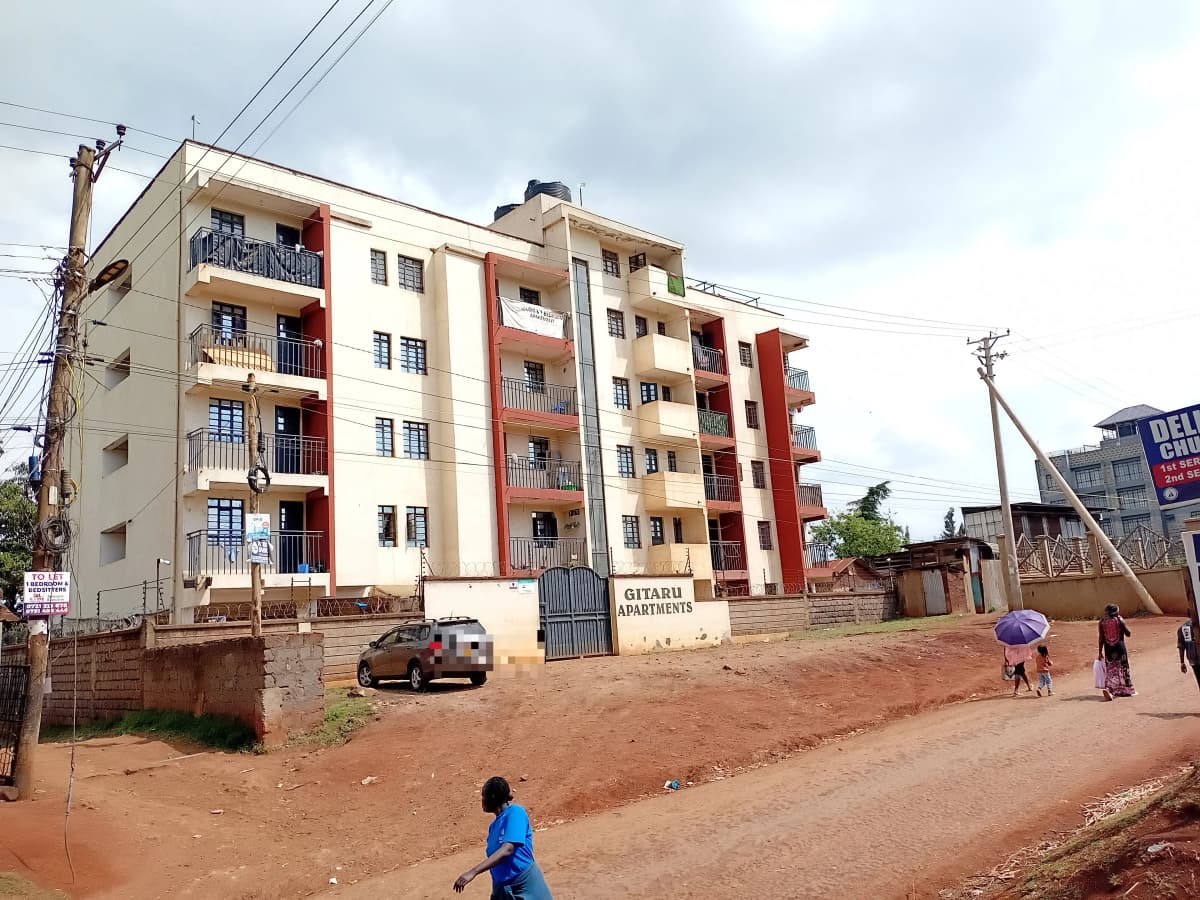 Multi-story residential building with red and cream facade