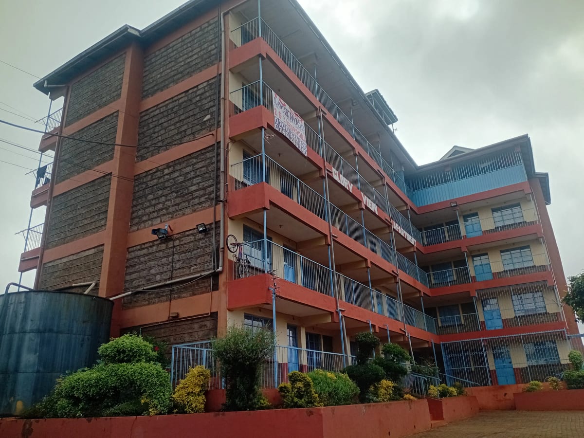 Multi-story residential building with red metal railings