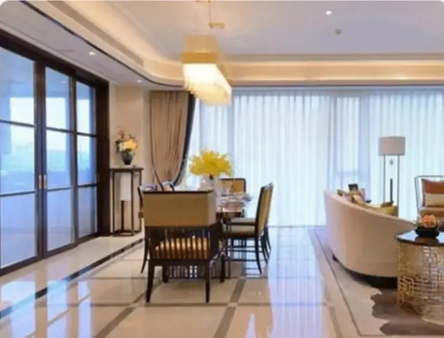 Elegant dining area with gold pendant light and sofa
