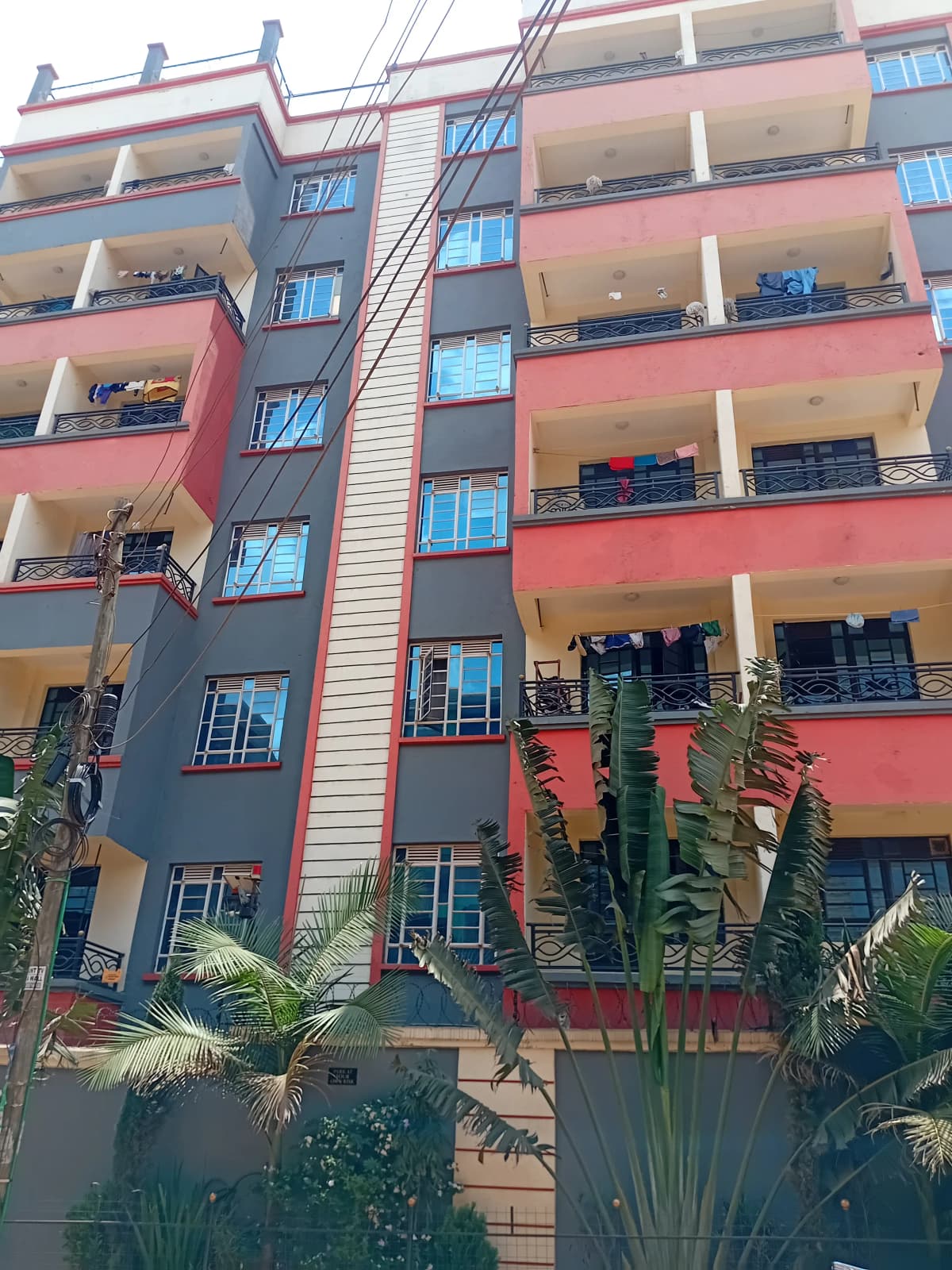 Multi-story residential building facade with colorful painted exterior