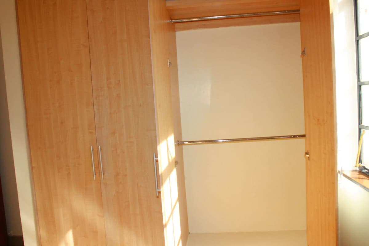 Bedroom with wooden wardrobe and bright natural light