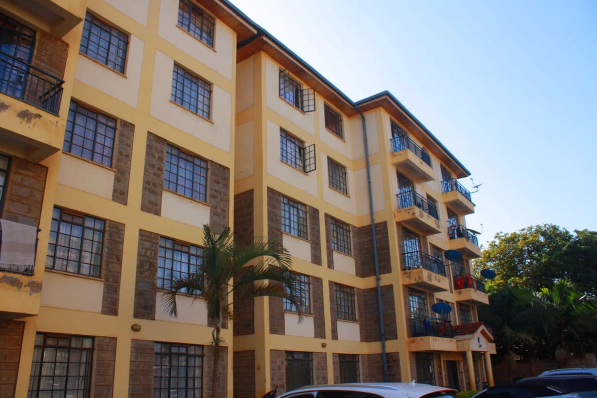 Multi-story apartment building with yellow facade and balconies