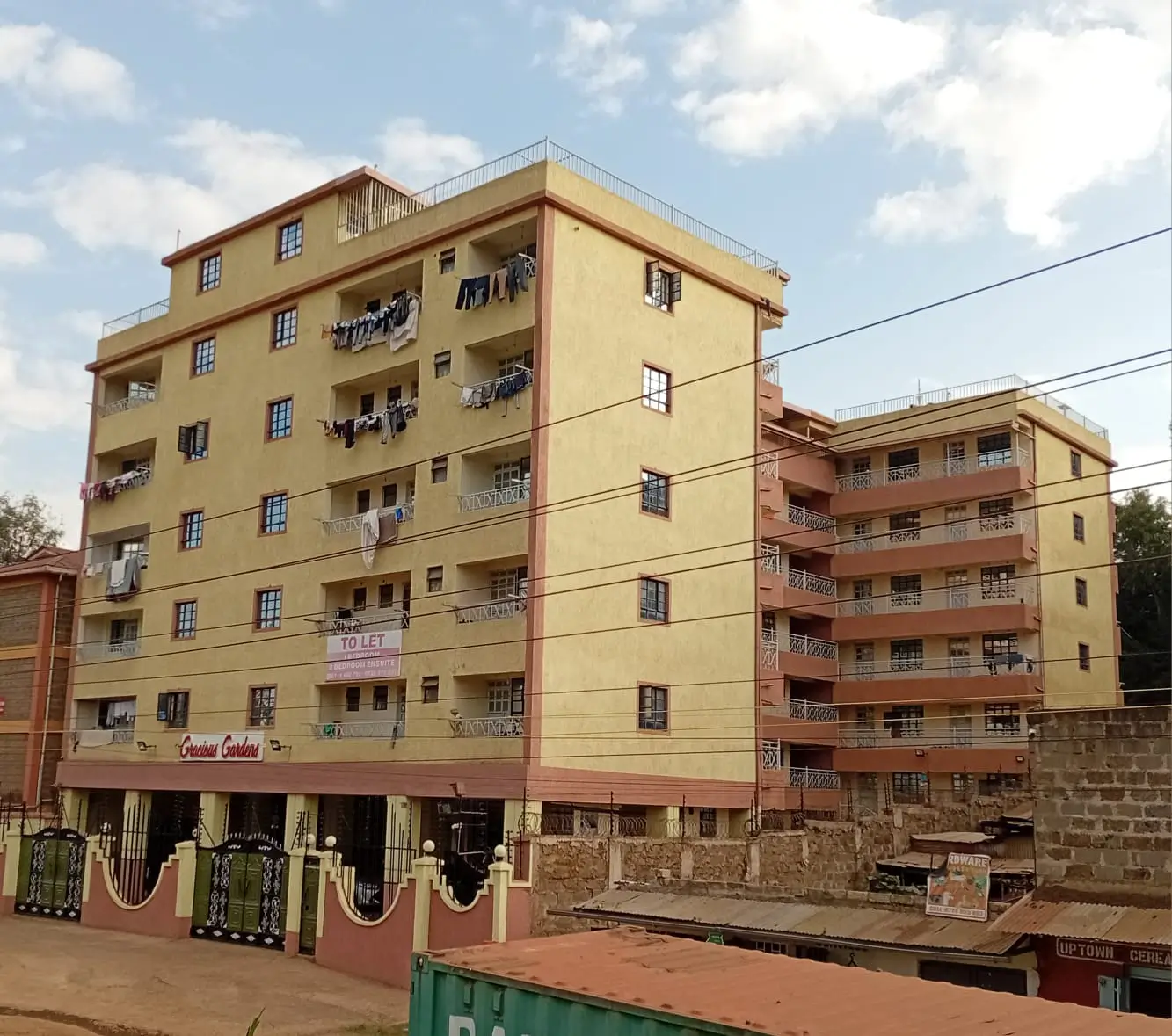 Multi-story residential apartment building facade with yellow and red painted exterior