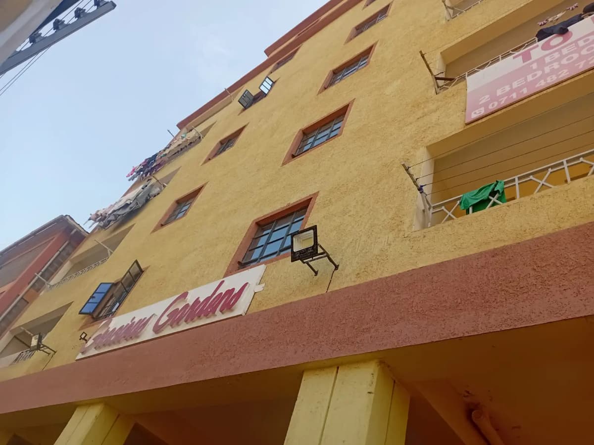 Yellow and terracotta apartment building facade with multiple windows