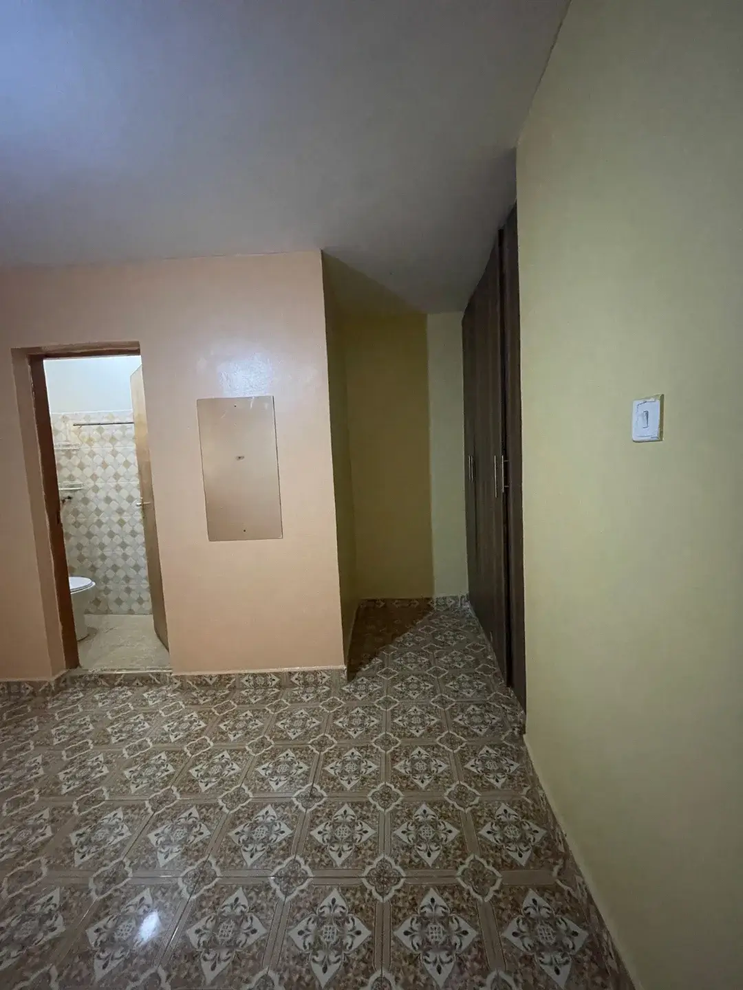 Corridor with patterned tiles and multiple doorways