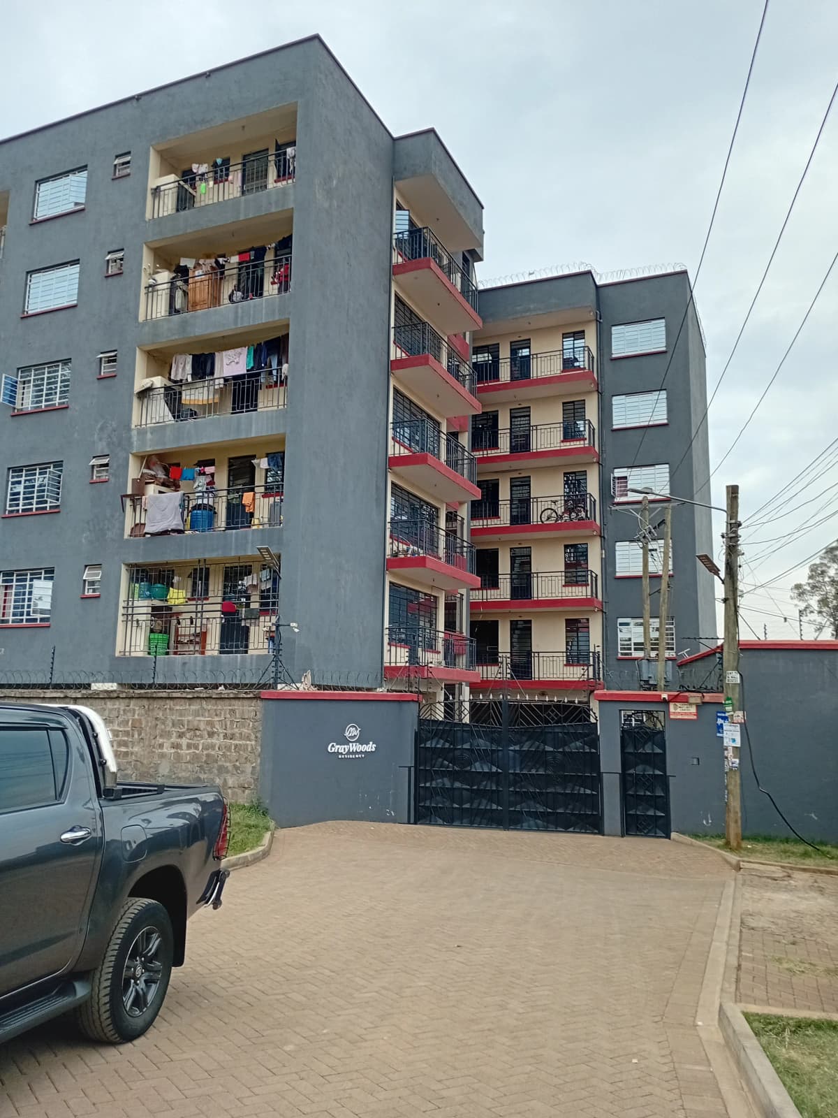Modern multi-story residential building with gated entrance