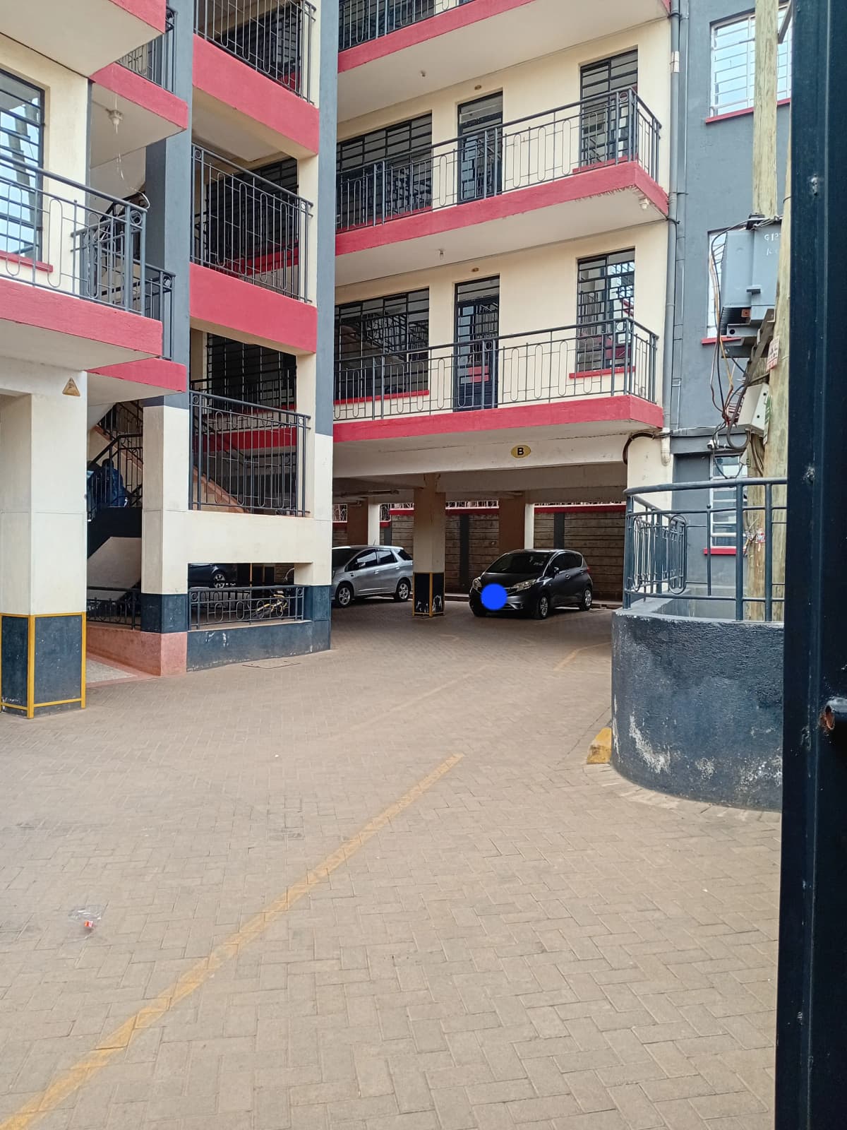 Multi-level apartment building with ground-floor parking area