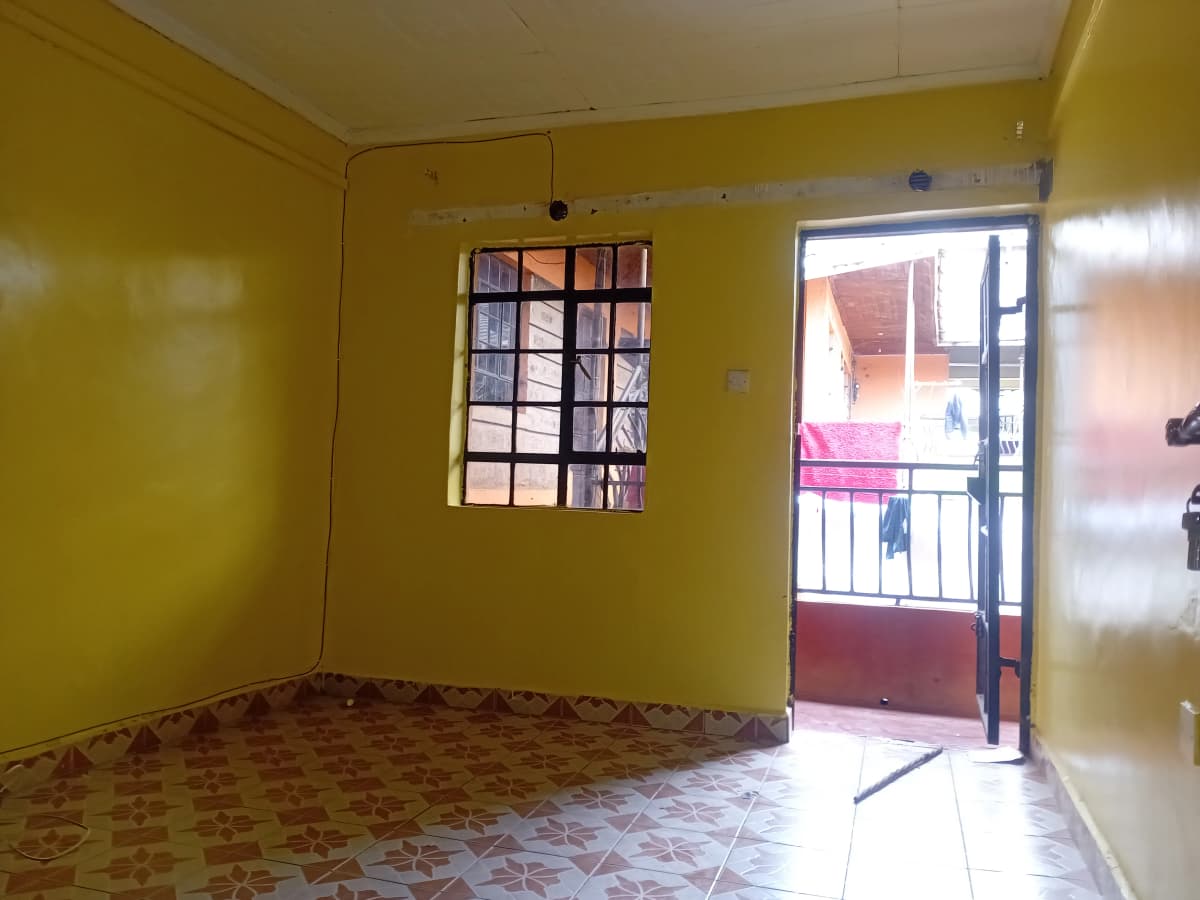 Bright yellow bedroom with balcony access and natural light