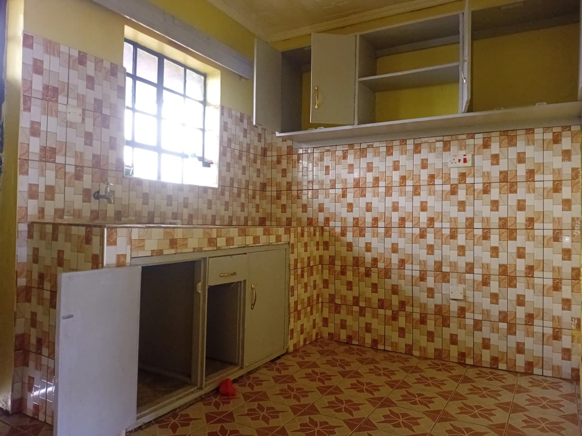 Kitchen with mosaic tile walls, cabinets, window, refrigerator