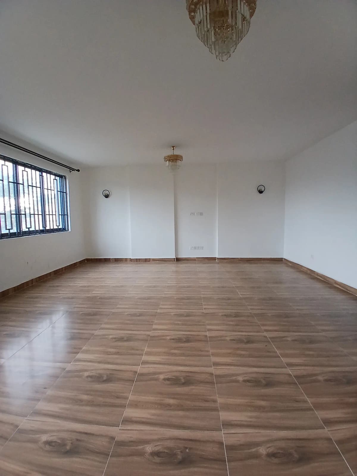 Spacious empty living room with wooden tile flooring