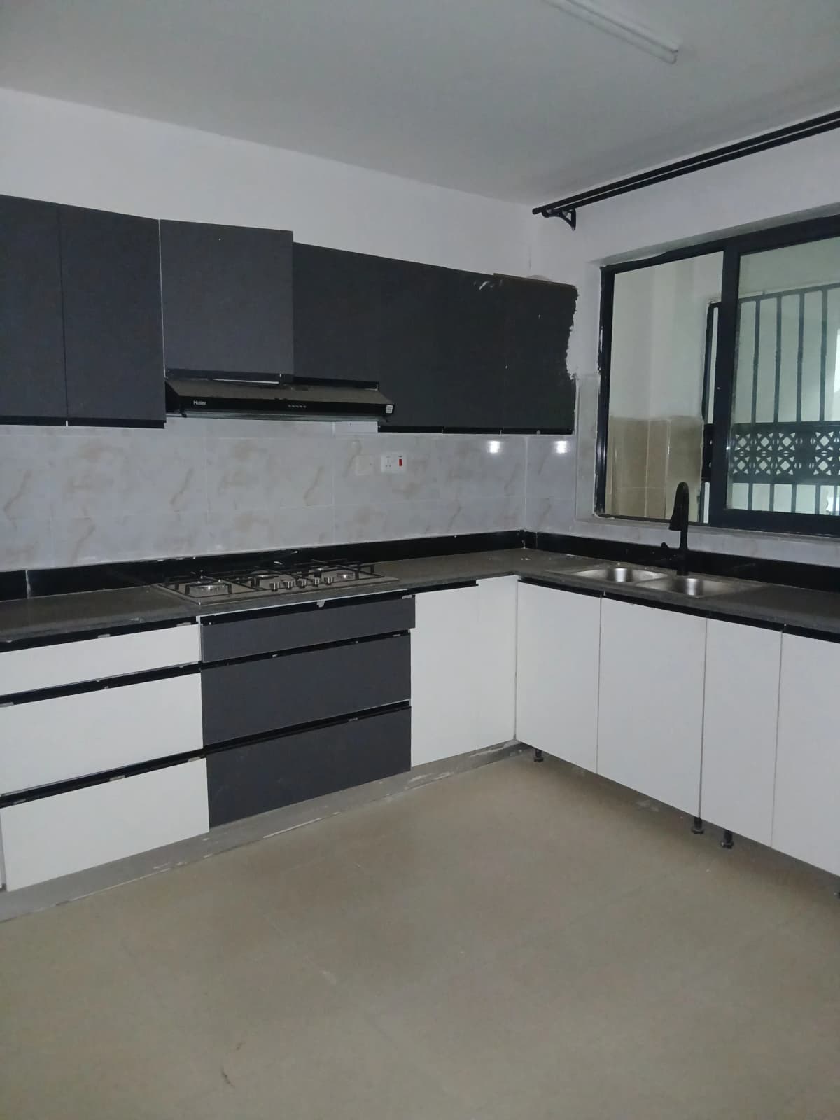 Modern L-shaped kitchen with black and white cabinetry