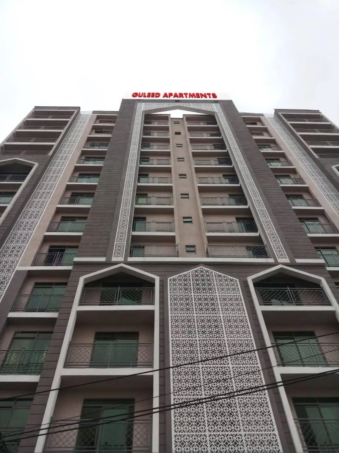 Modern multi-story apartment building facade with geometric patterns
