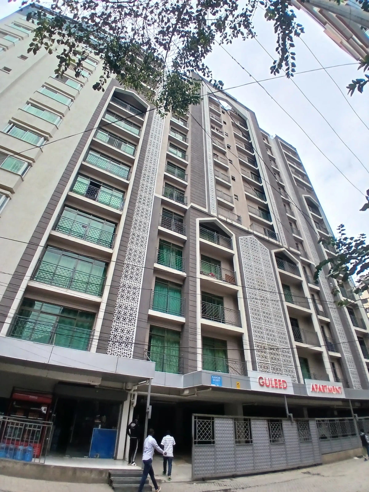 Modern multi-story residential building with brick facade and balconies