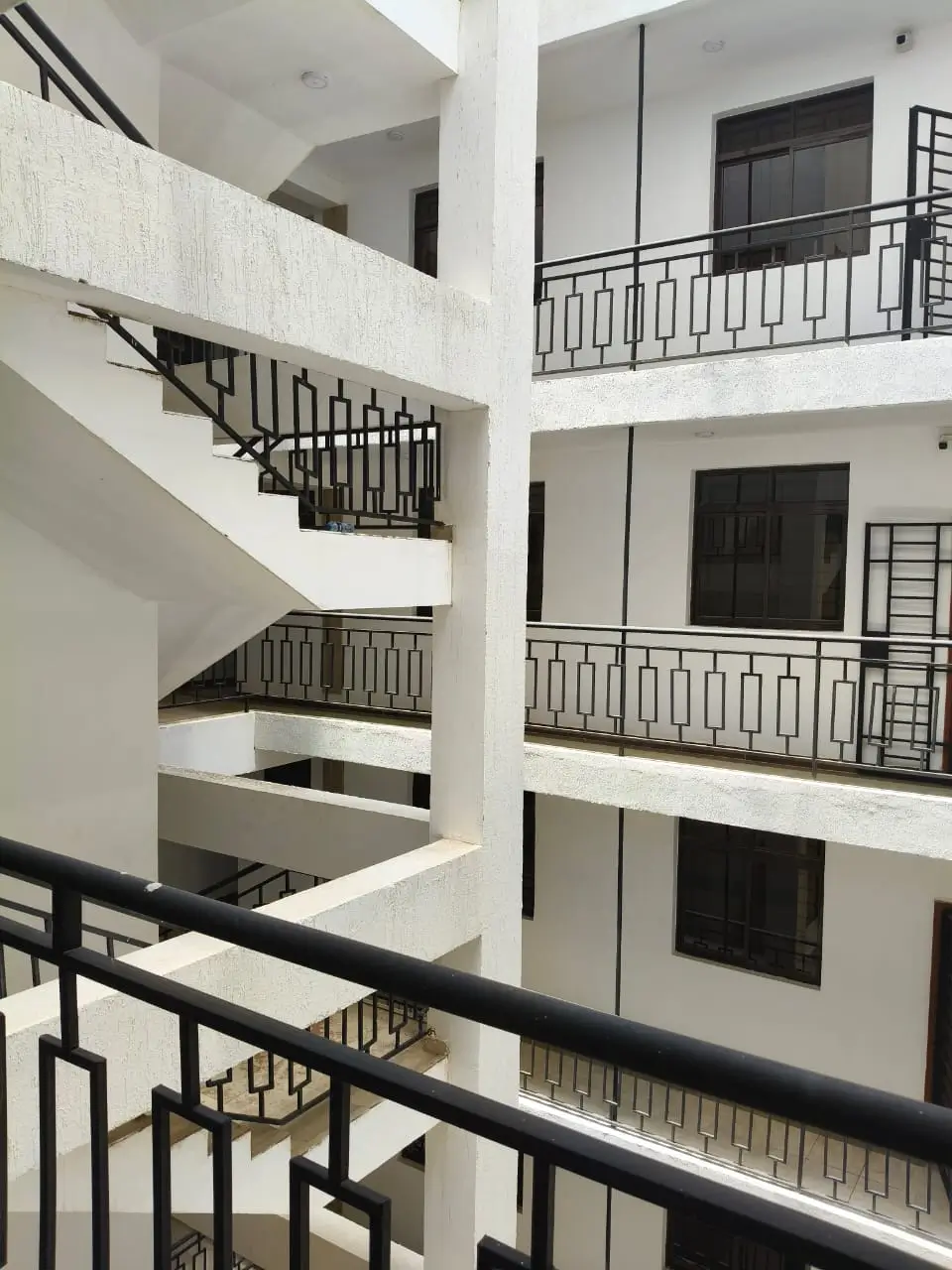 Multi-story building interior with staircase and balconies