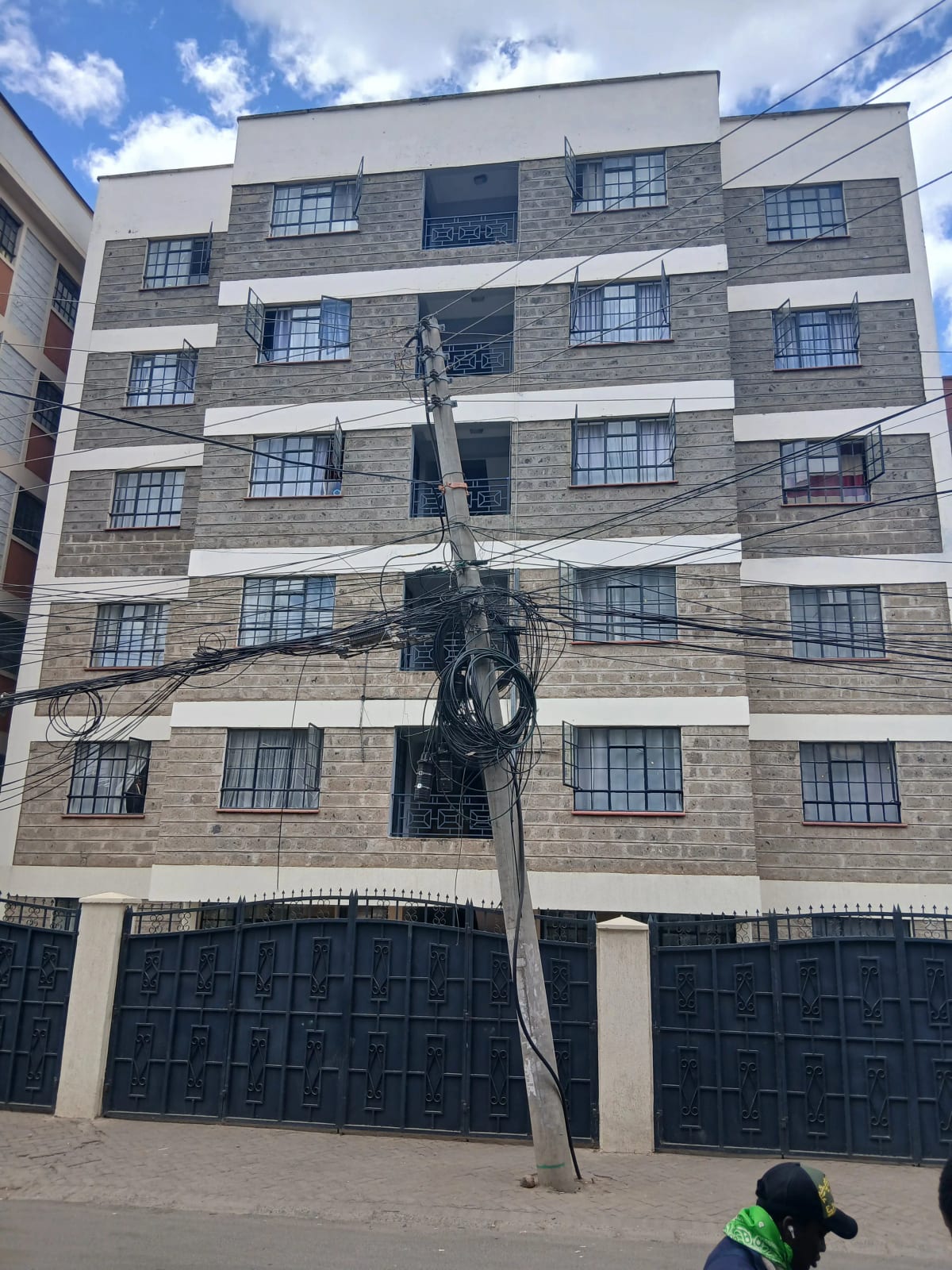 Modern multi-story residential building with stone facade