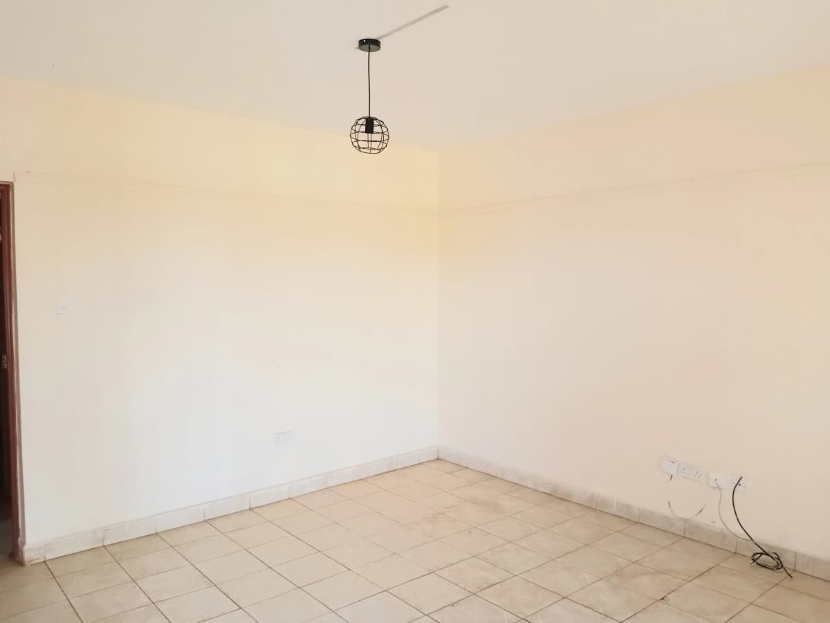 Empty room with tiled floor and minimal fixtures
