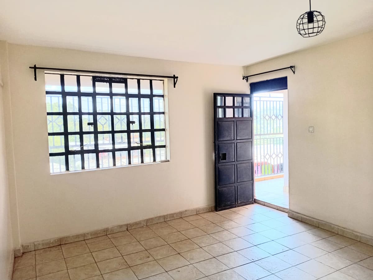 Bright living room with tiled floors and large window grilles