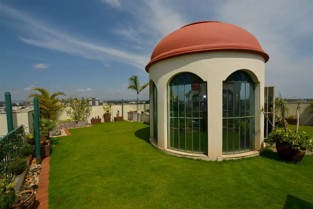 Rooftop garden with manicured lawn and modern curved structure