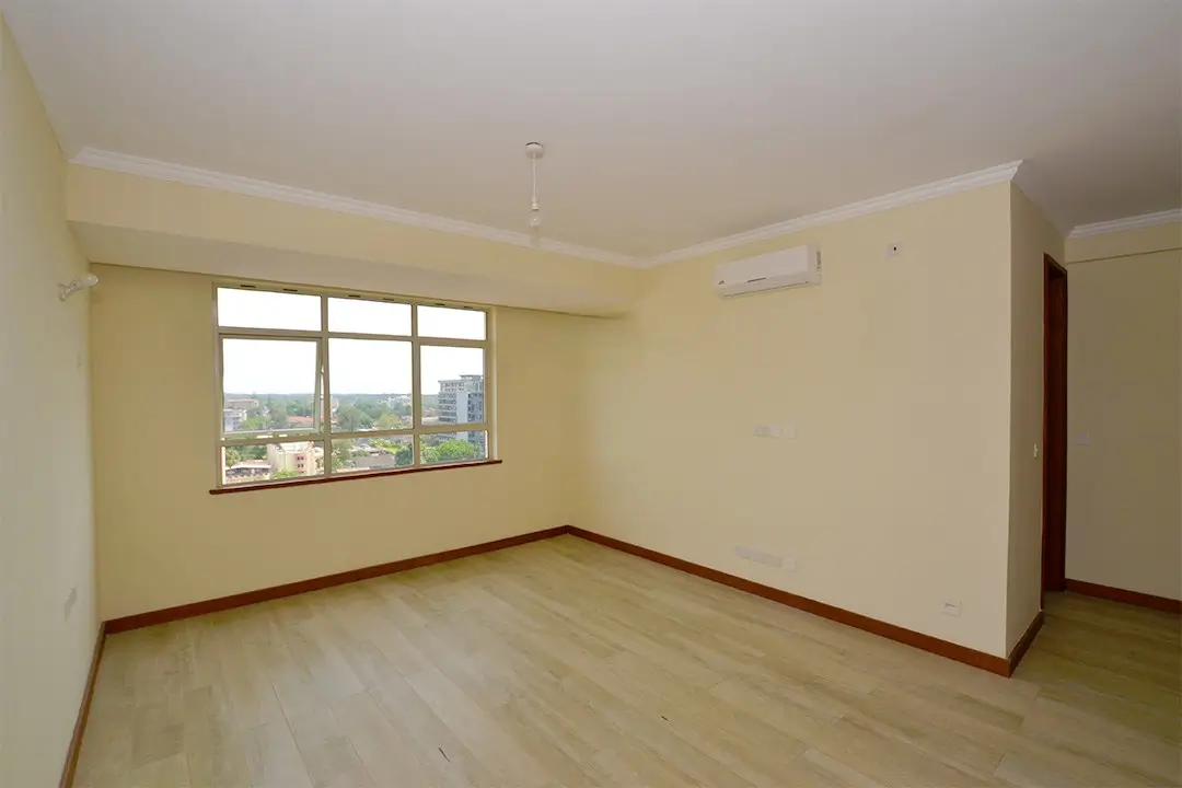 Spacious living room with large windows and city views