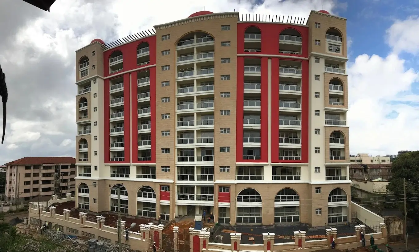 Modern multi-story residential building with red and beige facade