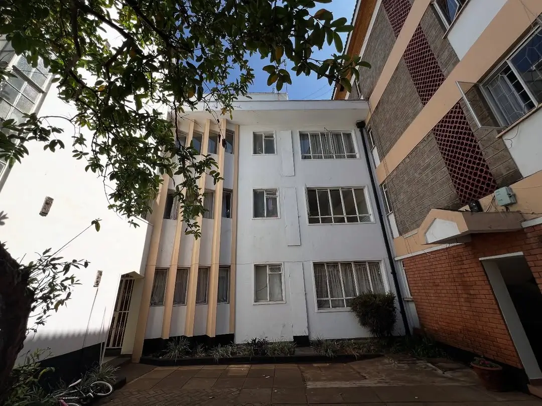 Multi-story residential building with white and brick facade